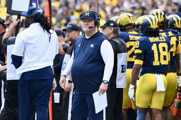 Acting Head Coach Biff Poggi and Michigan Team