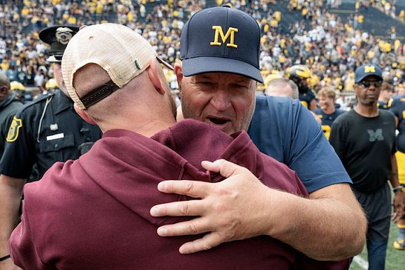Acting Head Coach Biff Poggi and Central Michigan Head Coach Matt Drinkall