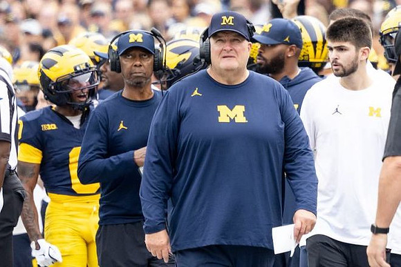 Acting Head Coach Biff Poggi and Michigan Team