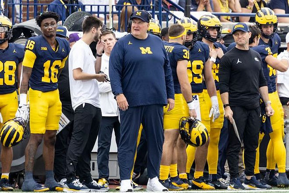 Acting Head Coach Biff Poggi and Michigan Team