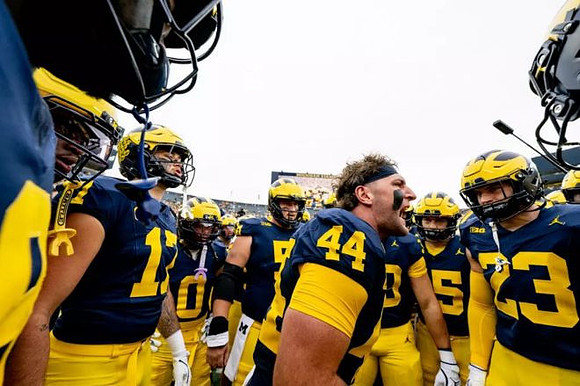 Max Bredeson (44) and Michigan Team