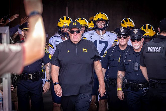Acting Head Coach Biff Poggi and Michigan Team