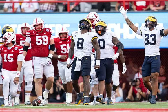 Derrick Moore (8), Tré Williams (0), and Dominic Nichols (33)