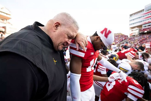 Acting Head Coach Biff Poggi and Michigan Team