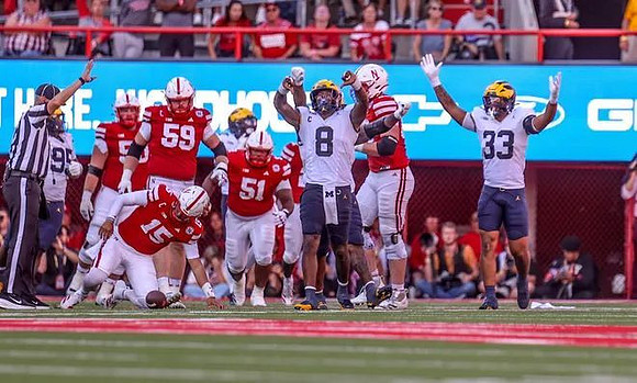 Trey Pierce (95), Derrick Moore (8), and Dominic Nichols (33)