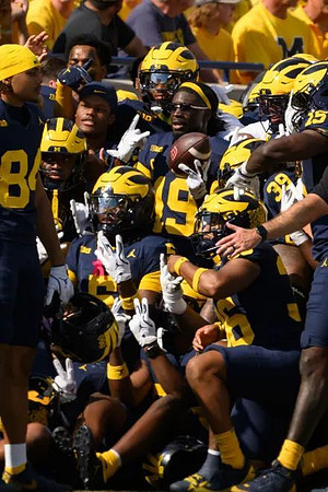 Rod Moore (19) and Michigan Team