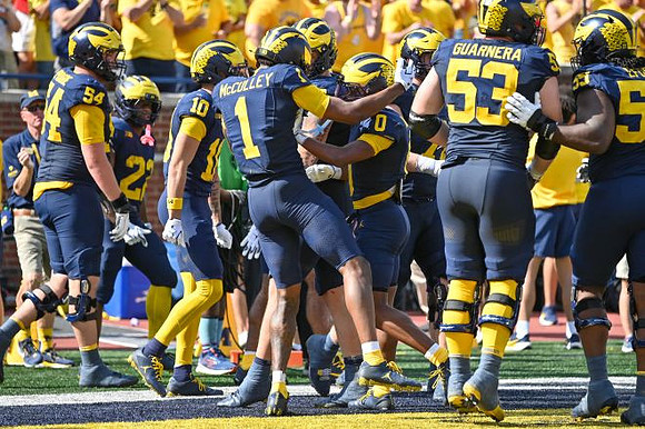 Donaven McCulley (1) and Michigan Team