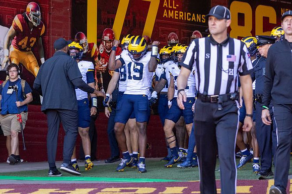 Sherrone Moore, Bryce Underwood (19), and Michigan Team
