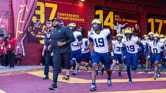 Sherrone Moore, Bryce Underwood (19), and Michigan Team