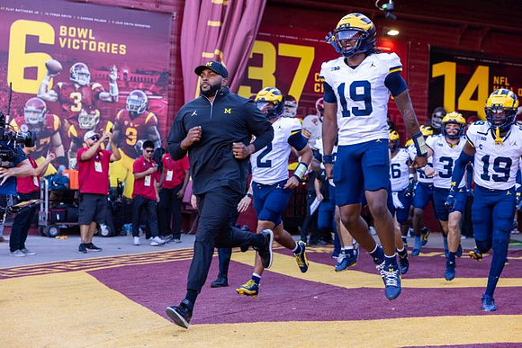 Sherrone Moore, Bryce Underwood (19), and Michigan Team