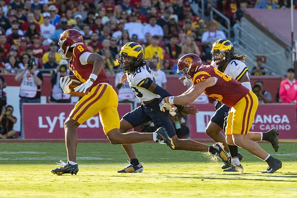 Jyaire Hill (20) and TJ Metcalf (7)