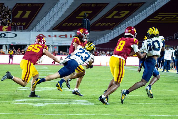 Cole Sullivan (23) and Jyaire Hill (20)