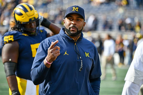 Nathan Efobi (55) and Sherrone Moore