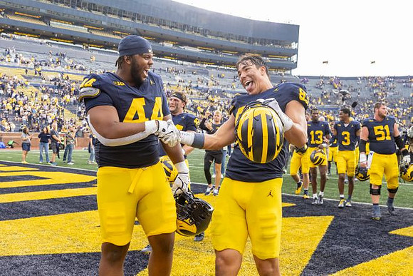 Damon Payne (44), Zack Marshall (83), and Michigan Team
