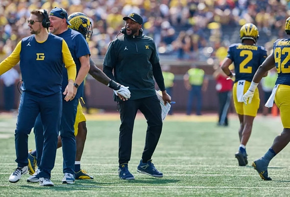Sherrone Moore, Will Johnson (2), and Ike Iwunnah (92)