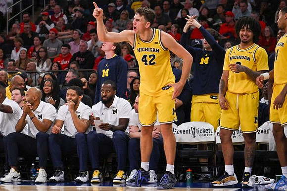 Will Tschetter (42) and Michigan Team