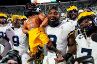 Derrick Moore (8), Michigan Team, and Paul Bunyan Trophy