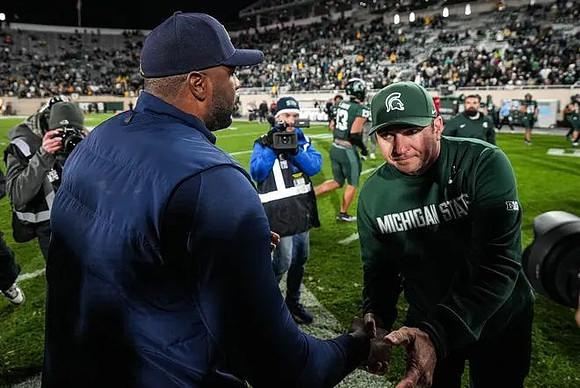 Sherrone Moore and Michigan State Head Coach Jonathan Smith