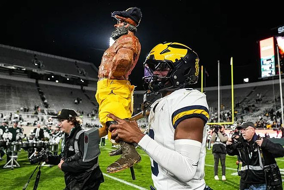 Semaj Morgan (0) and Paul Bunyan Trophy