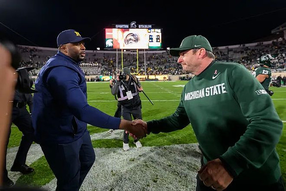 Sherrone Moore and Michigan State Head Coach Jonathan Smith