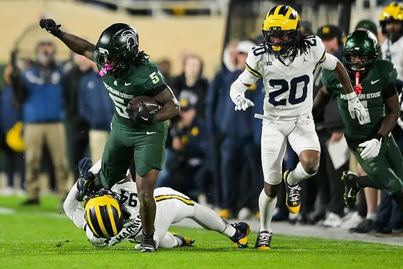 Nate Marshall (94) and Jyaire Hill (20)
