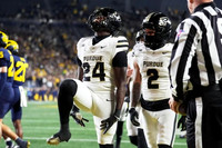Mason Curtis (25) and Jyaire Hill (20)