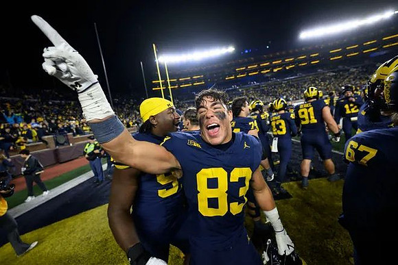 Zack Marshall (83) and Michigan Team