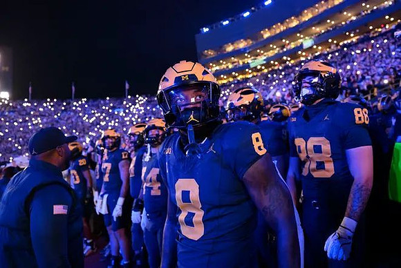 Derrick Moore (8) and Michigan Team