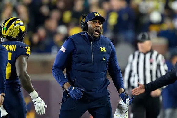 Ernest Hausmann (15) and Sherrone Moore