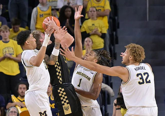 Yaxel Lendeborg (23), Trey McKenney (1), and Malick Kordel (32)