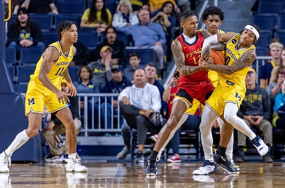 Isaiah Barnes (11), Tarris Reed Jr. (32), and Dug McDaniel (0)