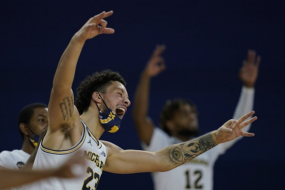 Rico Ozuna-Harrison (14), Brandon Johns Jr. (23), and Mike Smith (12)