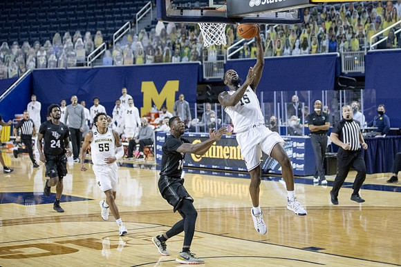 Eli Brooks (55) and Chaundee Brown Jr. (15)