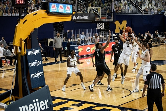 Chaundee Brown Jr. (15), Isaiah Livers (2), Brandon Johns Jr. (23), and Hunter Dickinson (1)