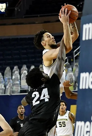 Brandon Johns Jr. (23) and Eli Brooks (55)