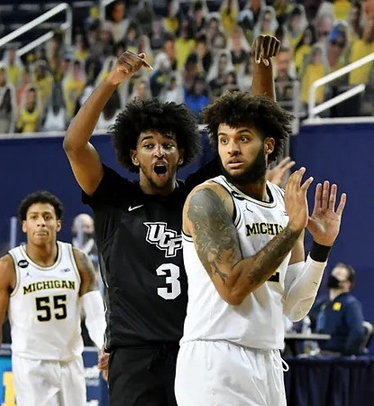 Eli Brooks (55) and Isaiah Livers (2)