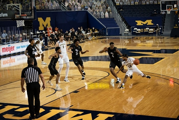 Chaundee Brown Jr. (15), Hunter Dickinson (1), and Mike Smith (12)