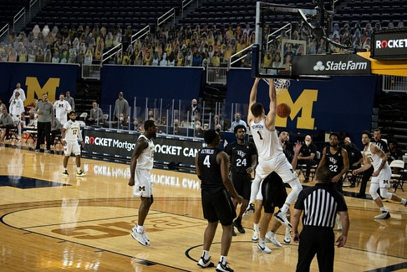 Mike Smith (12), Chaundee Brown Jr. (15), Hunter Dickinson (1), and Brandon Johns Jr. (23)