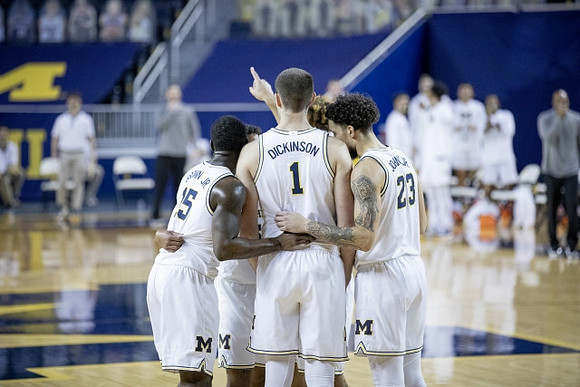 Chaundee Brown Jr. (15), Hunter Dickinson (1), and Brandon Johns Jr. (23)
