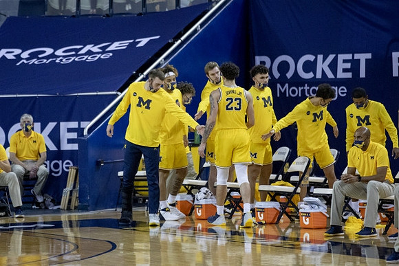 Brandon Johns Jr. (23) and Michigan Team