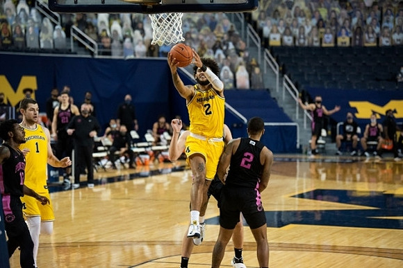 Hunter Dickinson (1) and Isaiah Livers (2)
