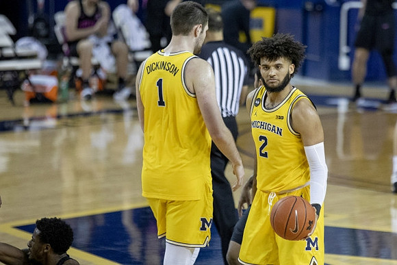 Hunter Dickinson (1) and Isaiah Livers (2)