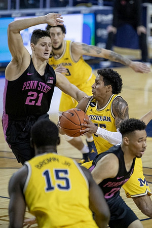 Chaundee Brown Jr. (15), Brandon Johns Jr. (23), and Eli Brooks (55)