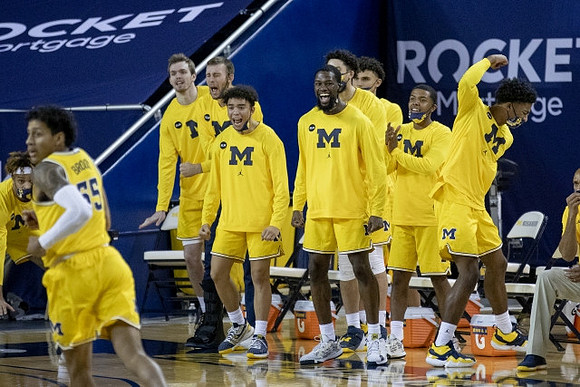 Eli Brooks (55) and Michigan Team