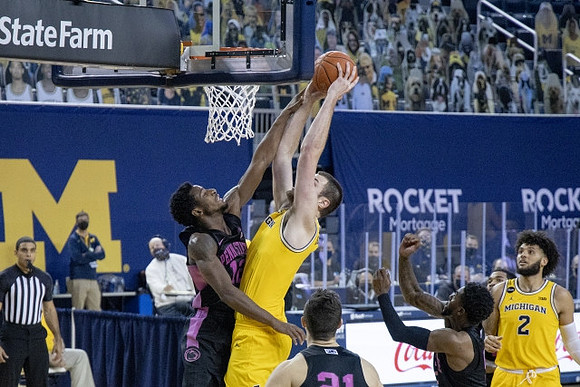 Hunter Dickinson (1) and Isaiah Livers (2)