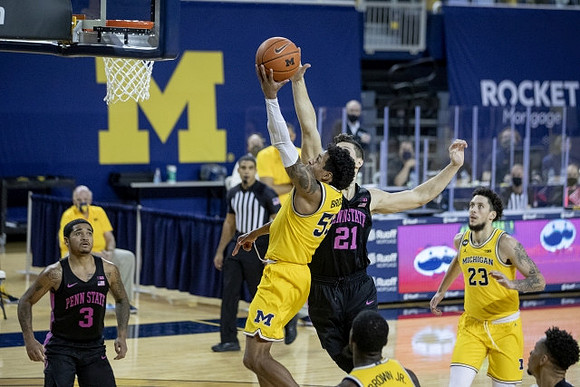 Eli Brooks (55), Chaundee Brown Jr. (15), and Brandon Johns Jr. (23)