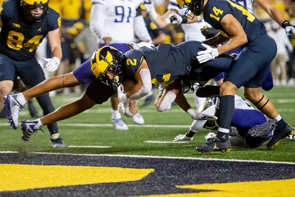 Joel Honigford (84), Blake Corum (2), and Roman Wilson (14)