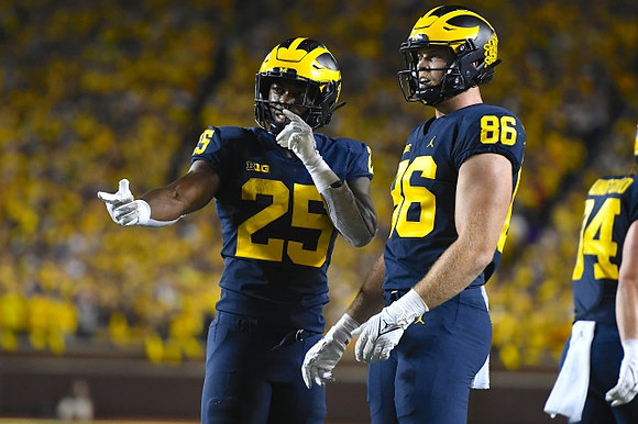 Hassan Haskins (25), Luke Schoonmaker (86), and Joel Honigford (84)