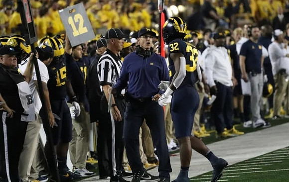 Jim Harbaugh, and Jaylen Harrell (32)