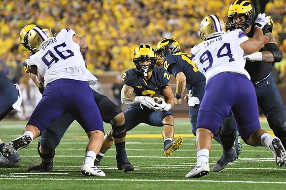 Blake Corum (2), and Cade McNamara (12)